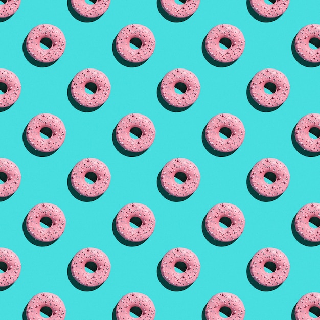Foto padrão de rosquinhas doces sobre um fundo azul.