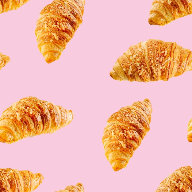 Padrão perfeito feito de croissant fresco com queijo isolado em fundo rosa