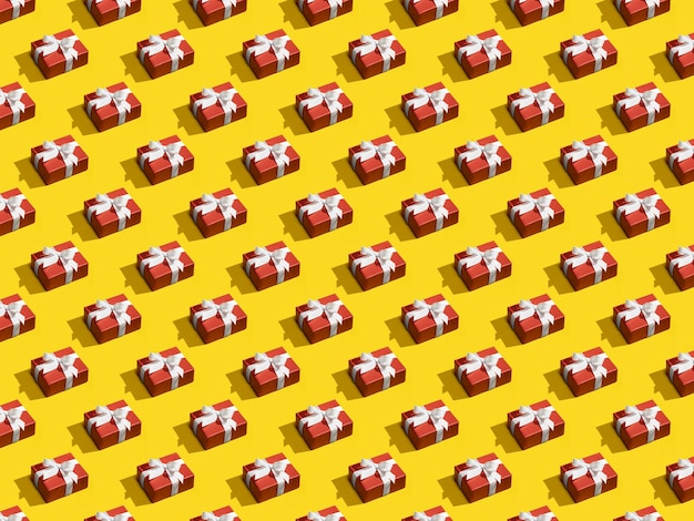 Padrão sem costura feito de caixas de presente vermelhas amarradas com fitas brancas em fundo amarelo Padrão de Natal criativo da caixa de presente Padrão isométrico de Natal Conceito de férias parabéns