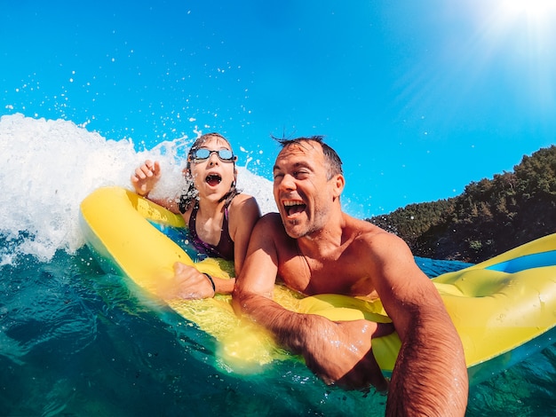 Padre e hija divirtiéndose en el mar