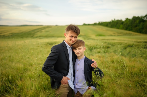 Padre e hijo en un campo de trigo verde