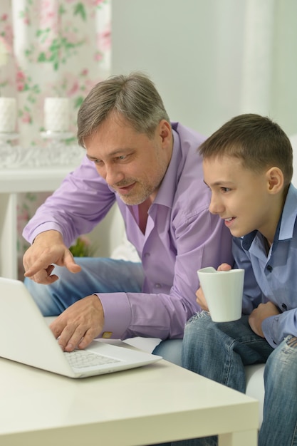 Padre e hijo con laptop en la mesa