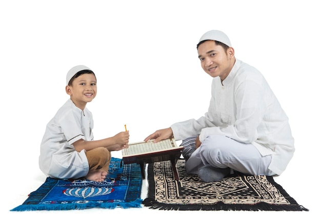 Padre e hijo leyendo el Corán