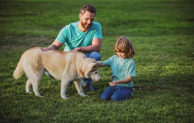 Padre e hijo con perro mascota pasar tiempo juntos al aire libre