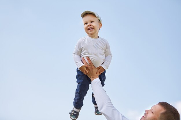 padre e hijo sobre un fondo de cielo azul. el concepto de paternidad