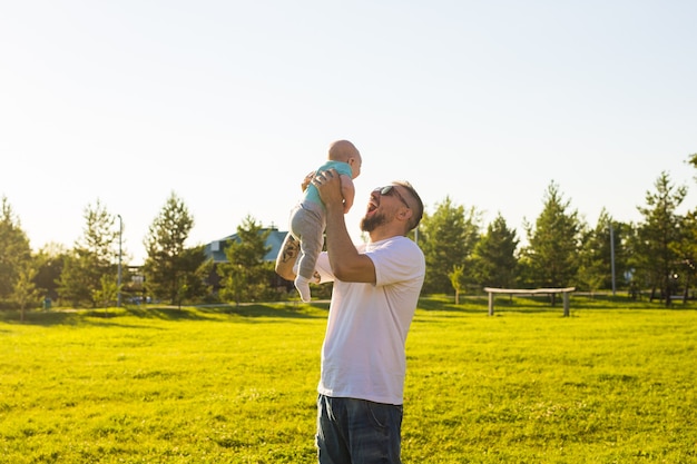 Padre feliz con hijo arrojando al bebé en el aire concepto de familia feliz día del padre y el niño