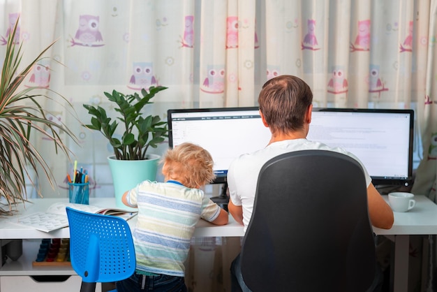 Padre con hijo tratando de trabajar desde casa durante la cuarentena Quédate en casa trabajando desde el concepto de casa durante el coronavirus