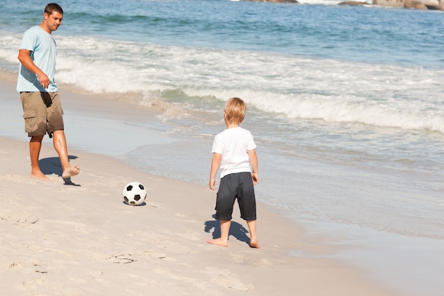 Padre jugando al fútbol con su hijo