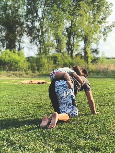 Foto padre jugando con su hija en un parque de césped