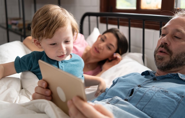 El padre del niño les lee cuentos a los niños antes de acostarse para relajarse y dormir profundamente hasta la mañana