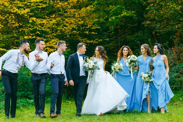 Padrinhos e damas de honra caminhando na cerimônia de casamento