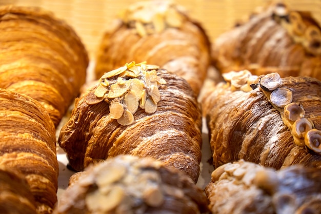 Pãezinhos frescos e deliciosos e croissants com nozes estão no balcão da padaria Croissants franceses com pistache e avelãs Bolos caseiros