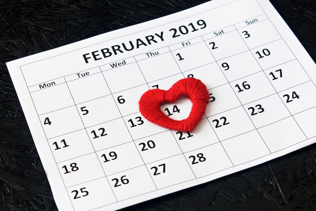 Página del calendario con corazones rojos el 14 de febrero.