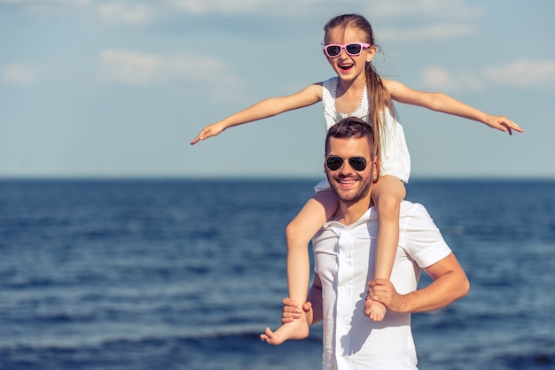 Pai bonito e sua filha pequena em óculos de sol