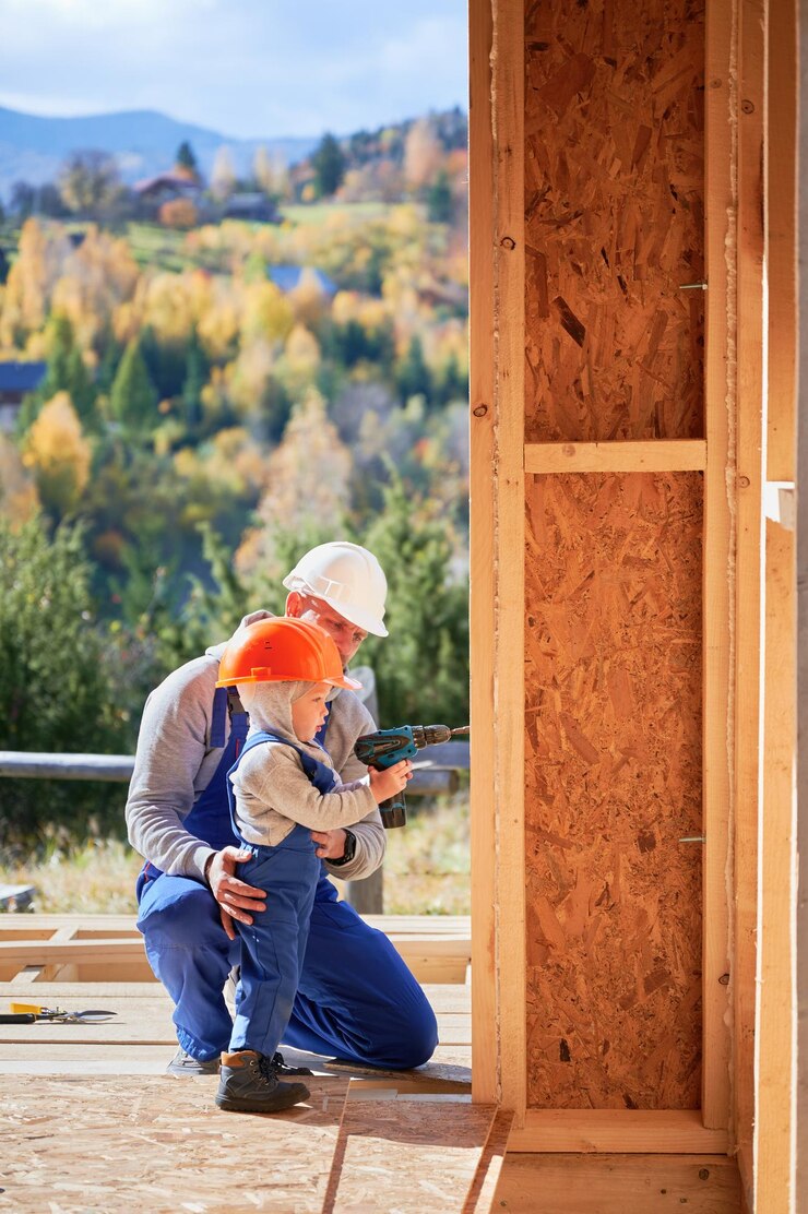 Foto pai com filho pequeno construindo uma casa de madeira