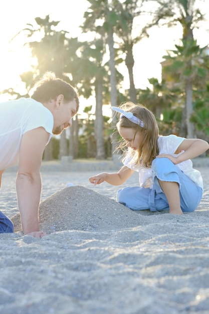 Pai e filha no verão no fundo da natureza Viagens de fim de semana com o pai Família feliz brincando e se divertindo juntos na praia