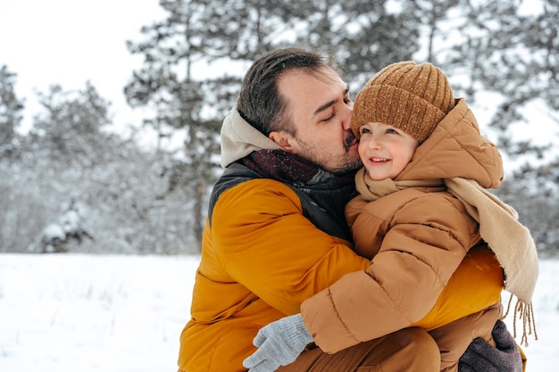 Pai e filho brincando no parque em dia de inverno