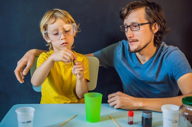 Pai e filho conduzem experimentos químicos em casa com lodo feito em casa