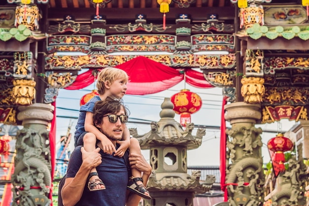 Pai e filho são turistas na rua no estilo português Romani na cidade de Phuket. Também chamada de Chinatown ou cidade velha