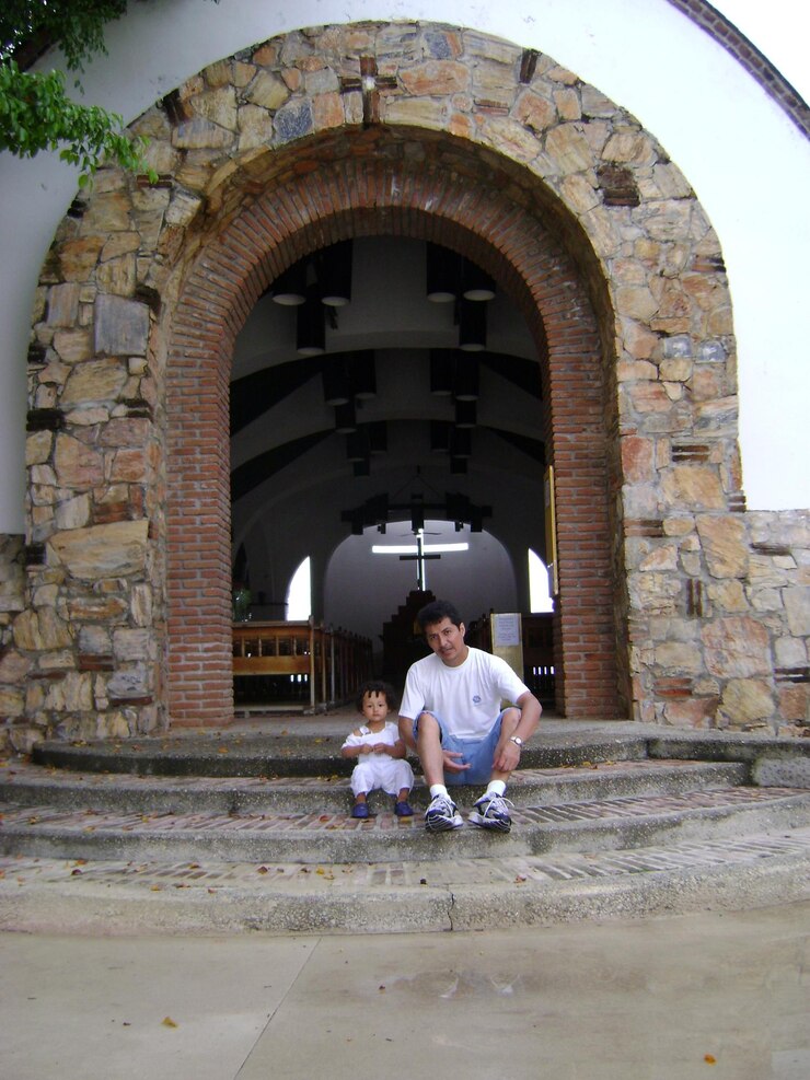 Foto pai e filho sentados na entrada da igreja