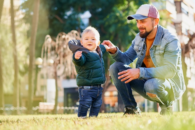 Pai jovem feliz andando com seu filho pequeno