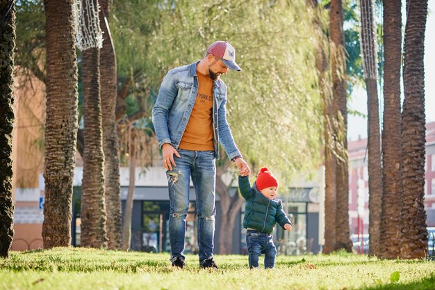 Pai jovem feliz andando com seu filho pequeno