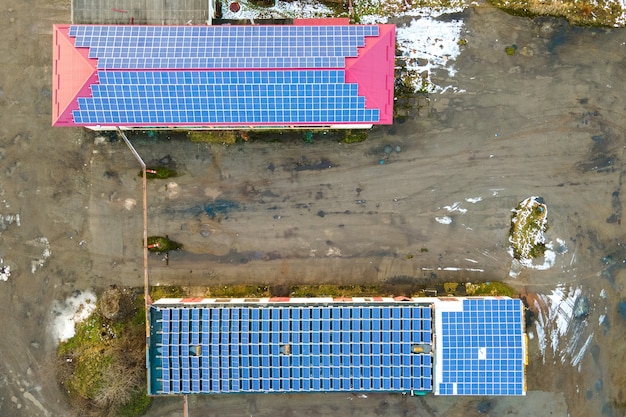Painéis solares fotovoltaicos azuis montados no telhado de um prédio industrial para a produção de eletricidade ecológica limpa. Produção do conceito de energia renovável.