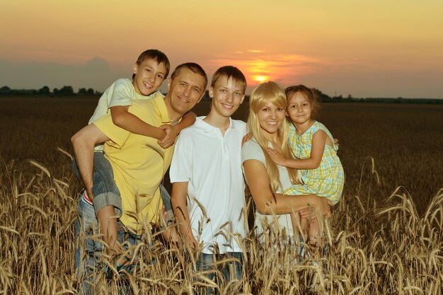 Pais felizes com filhos ao pôr do sol