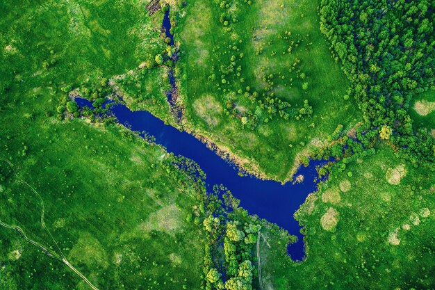 Paisagem aérea do lago azul em campo verde, vista superior da bela natureza do drone, paisagem sazonal de verão com espaço de cópia