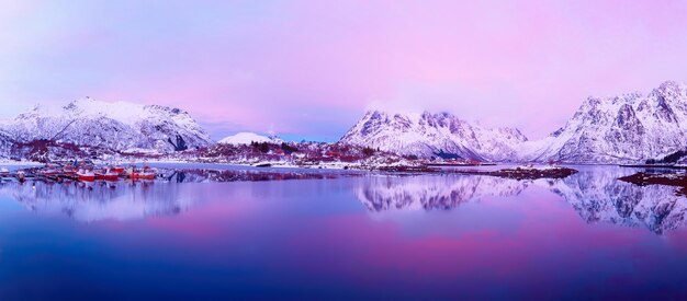 Paisagem com belo lago de inverno e montanhas nevadas ao pôr do sol nas Ilhas Lofoten, no norte da Noruega. Vista panorâmica