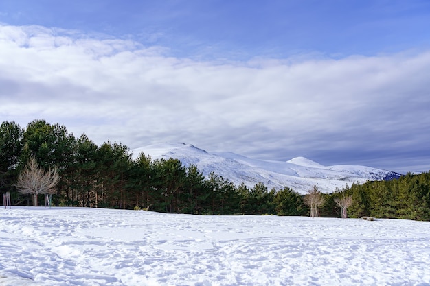 Paisagem de neve na montanha de madrid com sol, céu azul e alta montanha. morcuera.