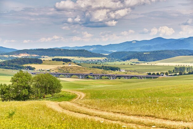 Foto paisagem de verão da eslováquia campos verdes de verão prados colinas das montanhas tatra viajar em férias estrada rural na região de spis eslováchia parque nacional de spissky hrad em fundo