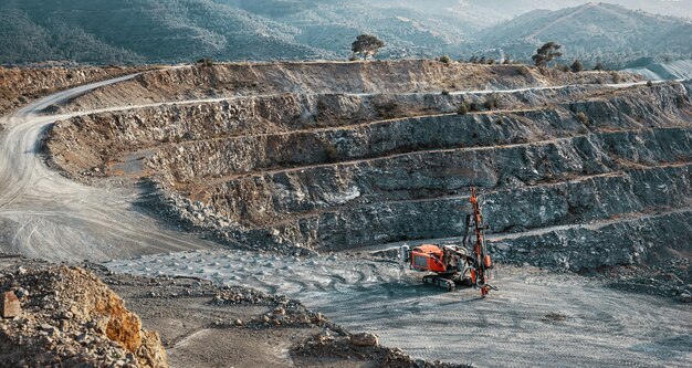 Foto paisagem industrial com máquina trituradora de pedra vermelha em pedreira