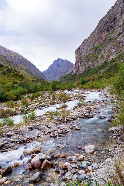 Paisagem montanhosa com um rio e uma cachoeira.