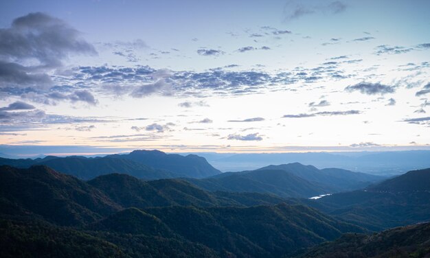 Paisagem montanhosa complexa pela manhã o sol está nascendo e a luz do sol pela manhã uma névoa fraca no topo da montanha