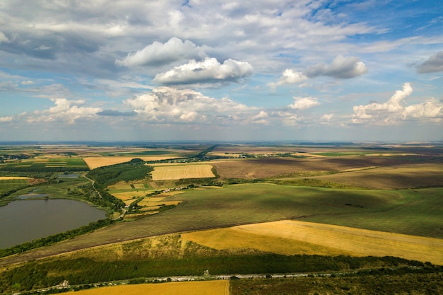 paisagem rural com campos de agricultura remendado amarelo e céu azul com nuvens brancas.