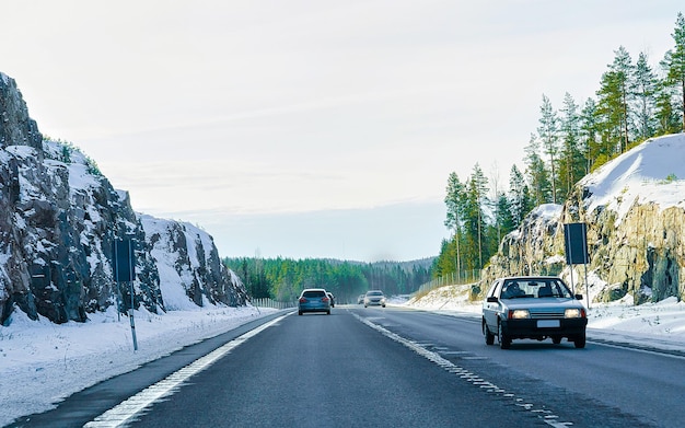 Paisaje con coche en carretera de nieve en Finlandia. Viaje de vacaciones en carretera con la naturaleza. Paisaje con unidad de invierno en viaje de vacaciones para recreación. Paseo en movimiento en Europa. Transporte en calzada.