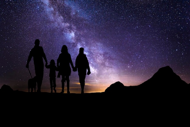 Paisaje con galaxia vía láctea y polvo espacial en el universo una familia con perros en un viaje