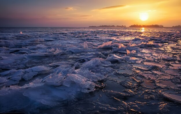 Paisaje de invierno con cielo al atardecer y mar congelado. Alba