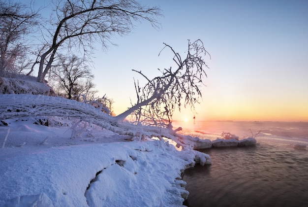 Paisaje de invierno con lago congelado y cielo al atardecer. Composición de la naturaleza.