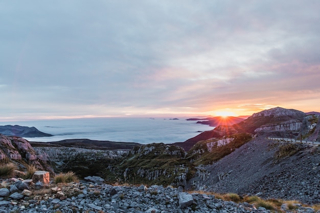 Paisaje de montañas al amanecer sobre las nubes, mar de nubes