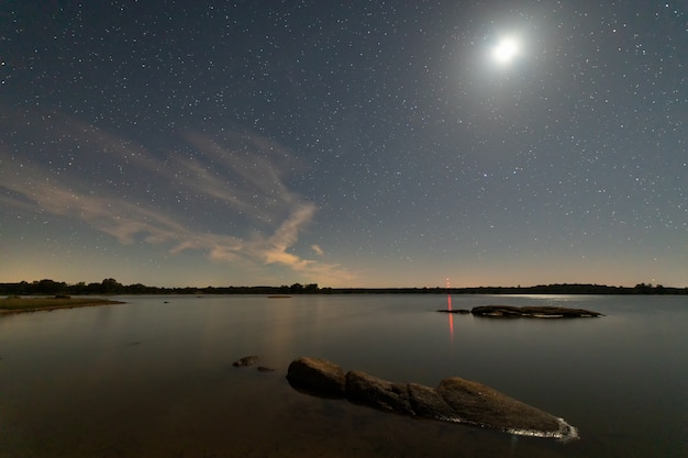 Paisaje nocturno con luna en el pantano de valdesalor. extremadura españa.