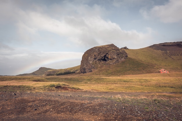 Paisaje del sur de Islandia con una casa y un arco iris