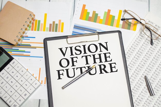 Foto las palabras de visión del futuro en un cuaderno blanco con calculadora y gráficos coloridos