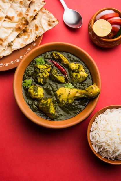 Palak o espinacas Pollo o Murg Saagwala servido en un bol con Naan y arroz