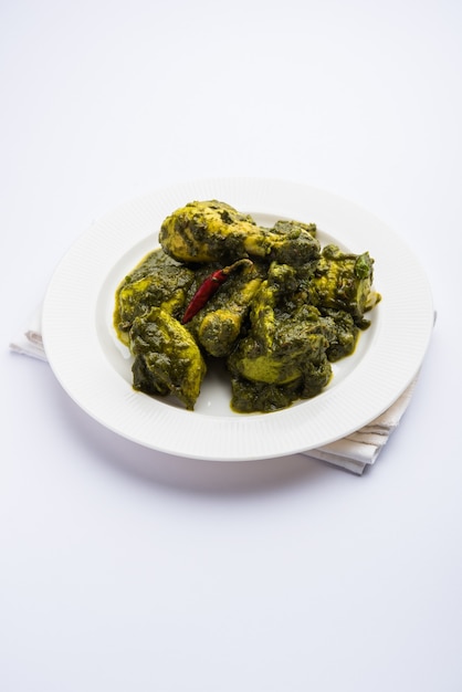 Palak oder Spinat Chicken oder Murg Saagwala serviert in einer Schüssel mit Naan und Reis