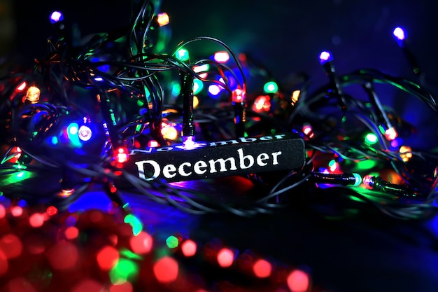 Palavra de dezembro no fundo do ano novo ilumina o conceito de Natal e ano novo
