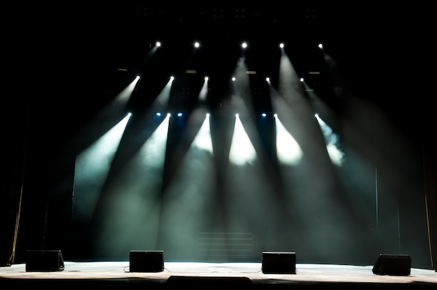 Palco livre com luzes, luz com luzes coloridas e fumaça.