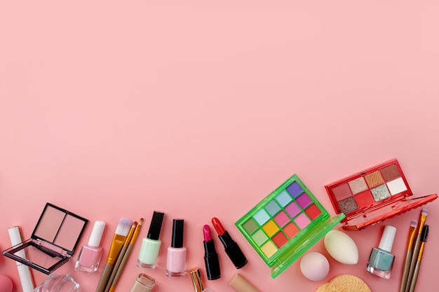 Paleta de sombras de verão brilhante e produtos de maquiagem em plano de fundo rosa vívido de verão