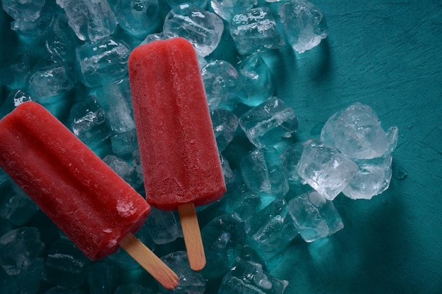 Foto paleta de fresa sobre fondo azul.